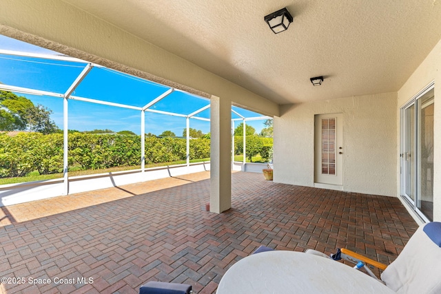 view of patio / terrace featuring glass enclosure