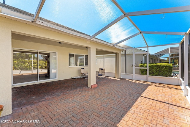 view of patio featuring a lanai