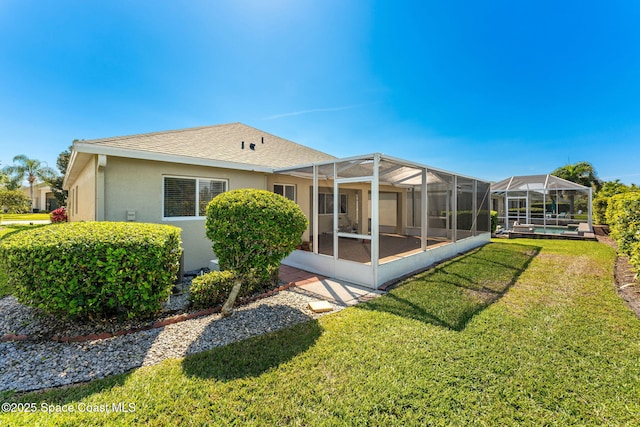 back of property with glass enclosure, a shingled roof, a lawn, an outdoor pool, and stucco siding