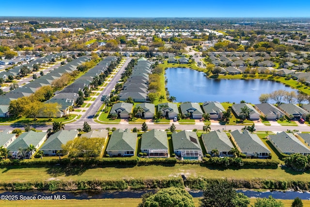 drone / aerial view with a water view and a residential view