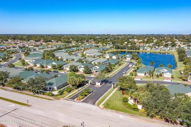 drone / aerial view featuring a water view and a residential view