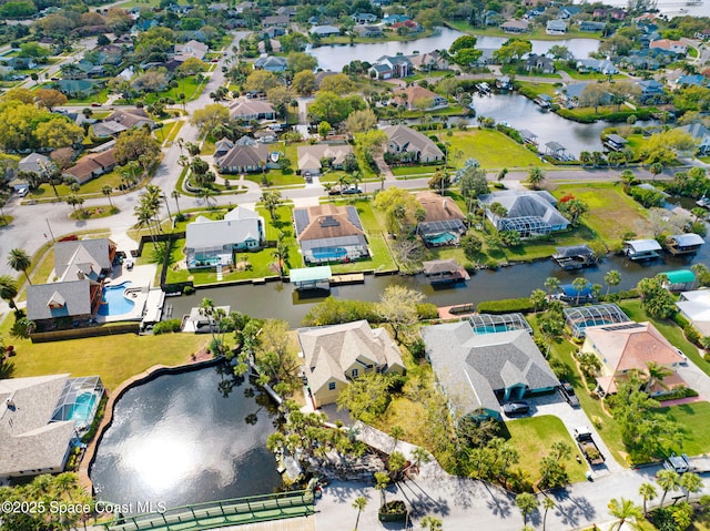 drone / aerial view featuring a residential view and a water view