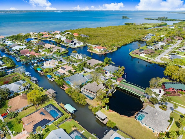 drone / aerial view with a residential view and a water view