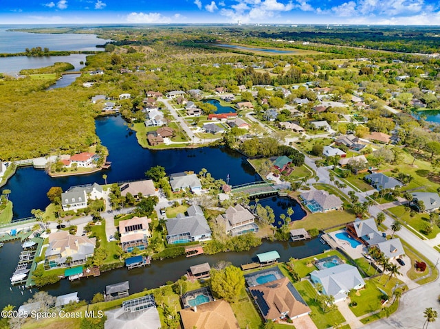 birds eye view of property with a water view and a residential view