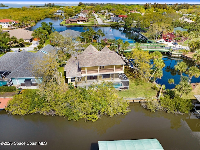 drone / aerial view with a water view and a residential view