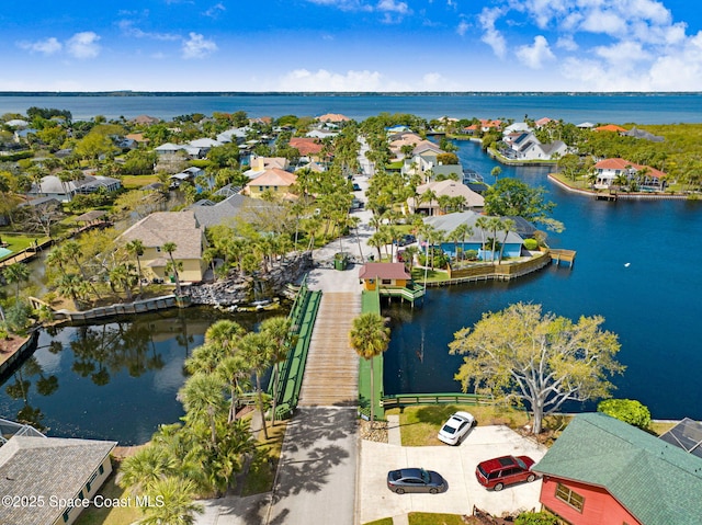 birds eye view of property with a water view and a residential view