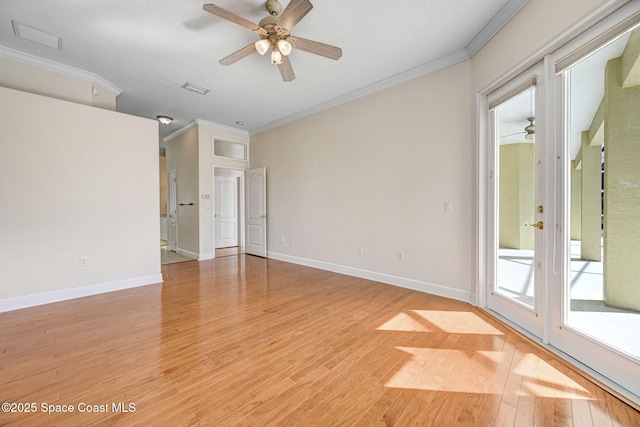 unfurnished room with ornamental molding, visible vents, light wood-style flooring, and baseboards