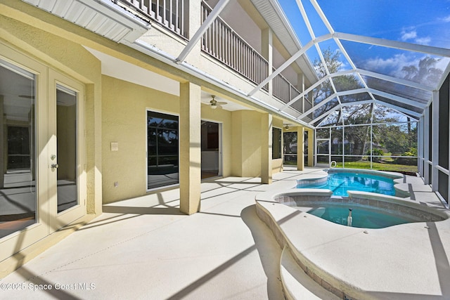 view of swimming pool featuring a pool with connected hot tub, a patio, and a lanai