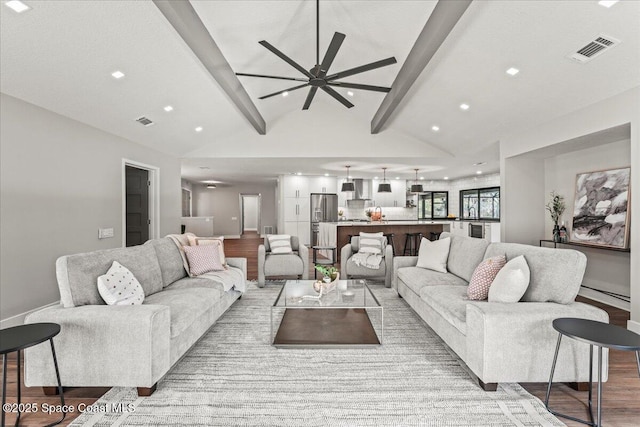 living area featuring recessed lighting, visible vents, vaulted ceiling with beams, and wood finished floors