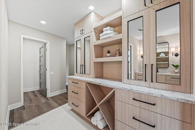 walk in closet featuring dark wood-style floors and visible vents