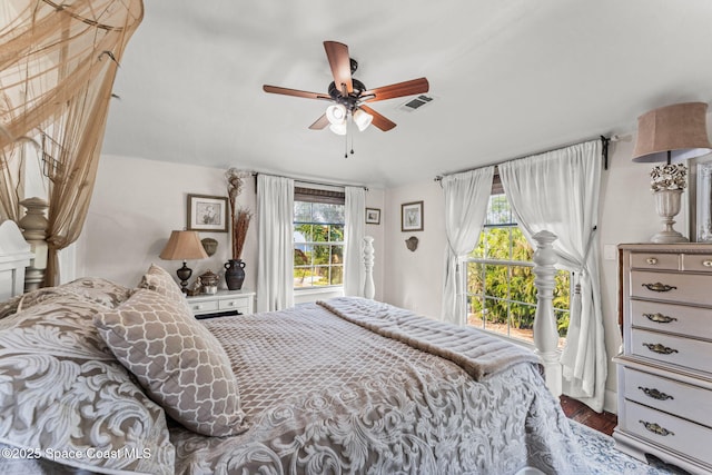 2109 Indian River Dr, Cocoa, FL 32922 - bedroom featuring access to exterior, multiple windows, wood finished floors, and ceiling fan