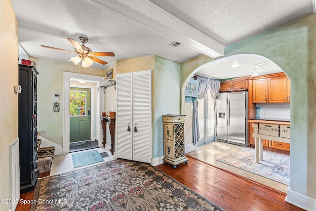 2109 Indian River Dr, Cocoa, FL 32922 - entryway with arched walkways, hardwood / wood-style flooring, ceiling fan, a textured ceiling, and beam ceiling