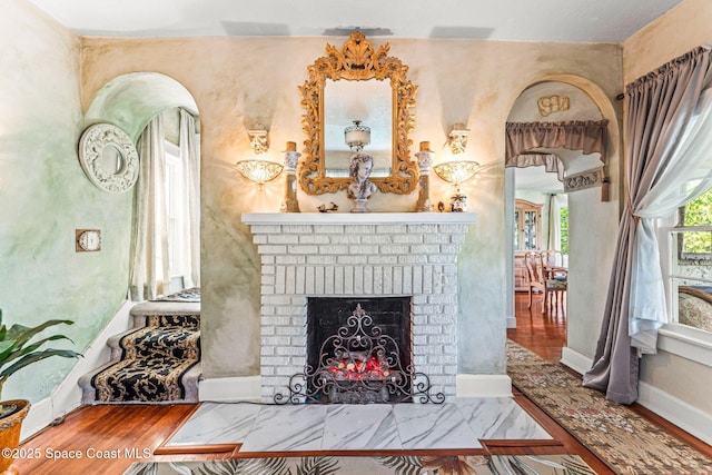 2109 Indian River Dr, Cocoa, FL 32922 - living area featuring a fireplace, baseboards, and wood finished floors