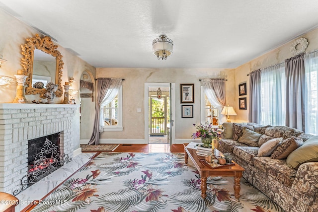 2109 Indian River Dr, Cocoa, FL 32922 - living room with a brick fireplace, baseboards, and wood finished floors