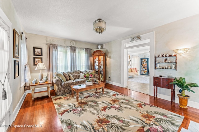 2109 Indian River Dr, Cocoa, FL 32922 - living area with hardwood / wood-style floors, baseboards, and a textured ceiling