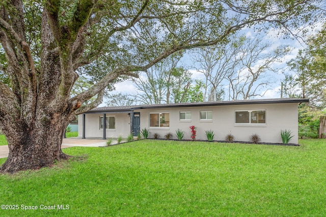 ranch-style home with stucco siding and a front yard