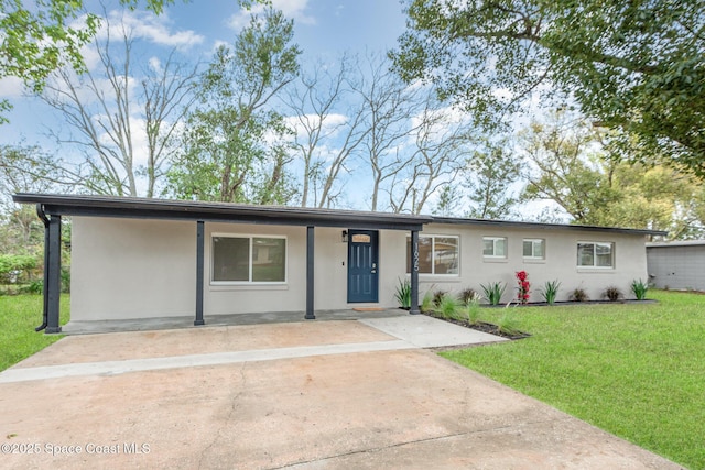 ranch-style home with a front yard and stucco siding