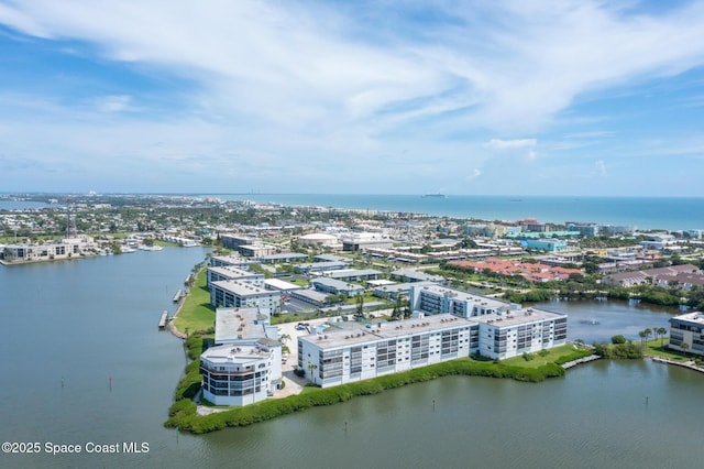 drone / aerial view featuring a water view and a city view