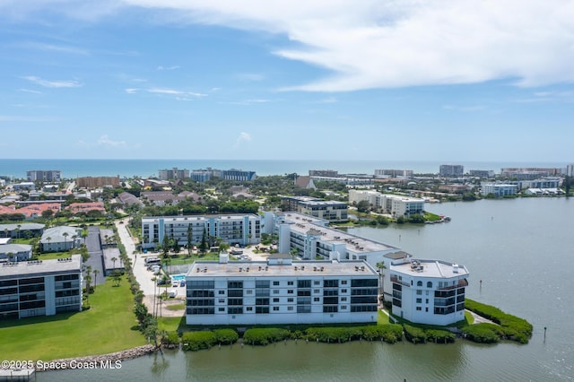 birds eye view of property featuring a water view and a city view