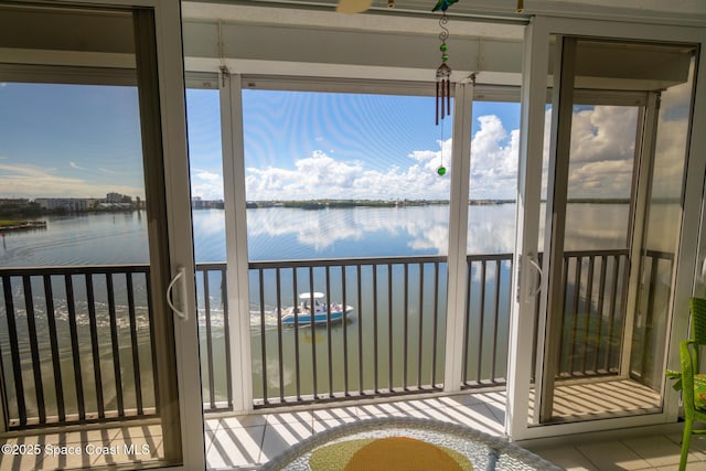 unfurnished sunroom featuring a water view and a healthy amount of sunlight