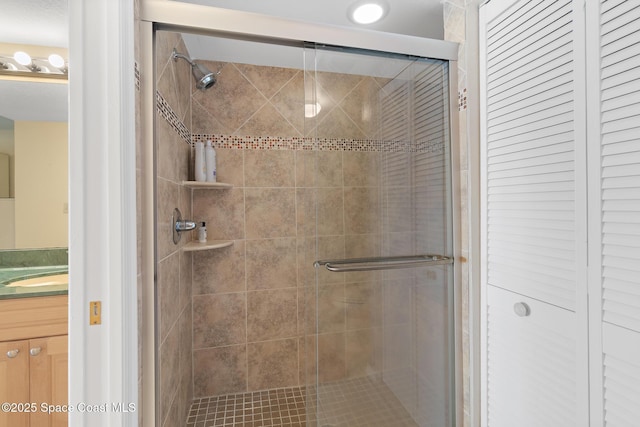 full bathroom featuring vanity and a shower stall