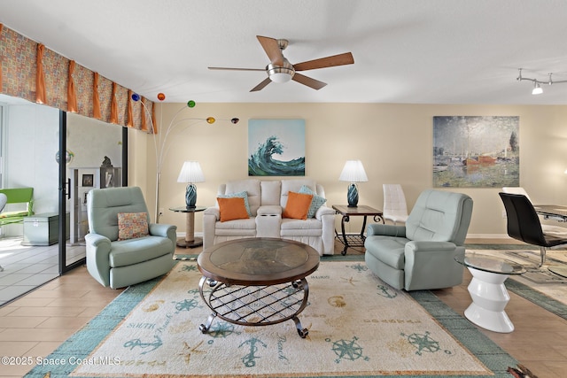 living area with ceiling fan and wood finished floors