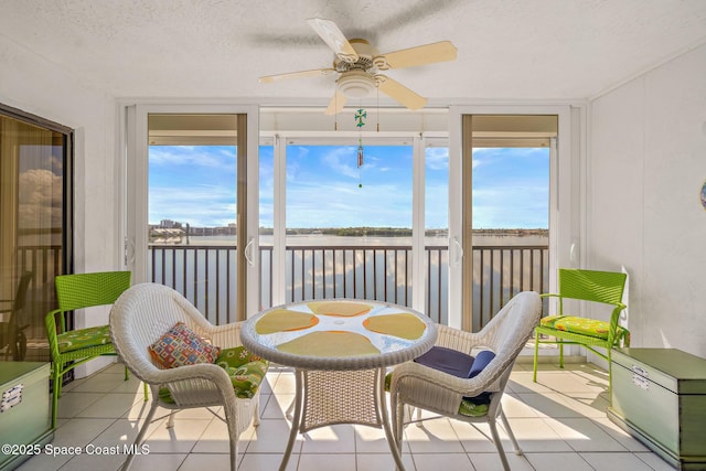 sunroom featuring ceiling fan