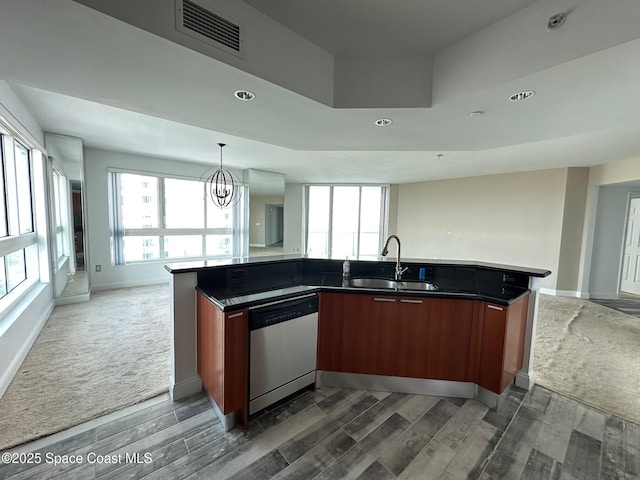 kitchen featuring dark colored carpet, visible vents, open floor plan, a sink, and dishwasher