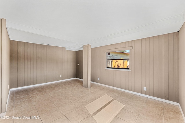 empty room with baseboards and tile patterned floors