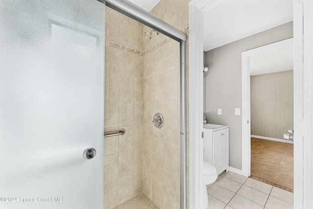 full bathroom with tile patterned flooring, baseboards, a shower stall, and toilet