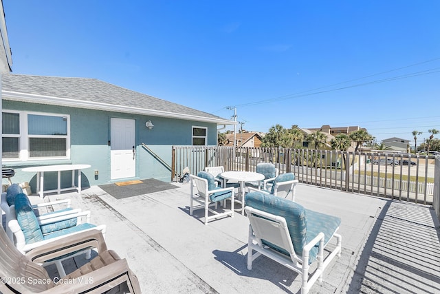 view of patio / terrace featuring fence and outdoor dining space