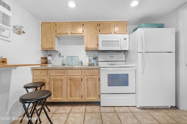 kitchen with tasteful backsplash, light countertops, light tile patterned flooring, a sink, and white appliances