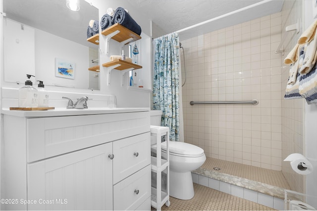 full bath featuring a tile shower, vanity, toilet, and tile patterned floors