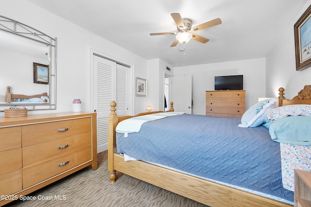 carpeted bedroom featuring a closet and a ceiling fan