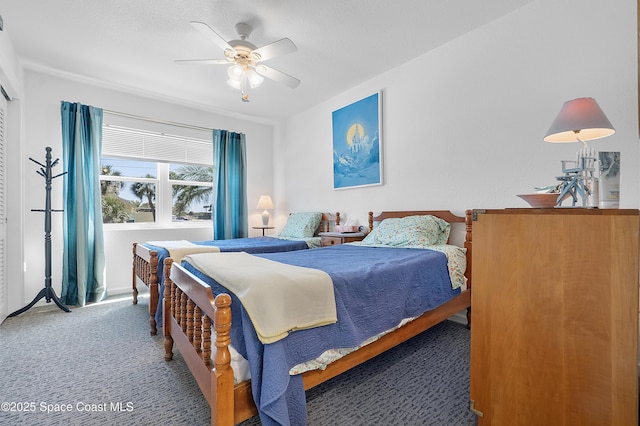 carpeted bedroom featuring ceiling fan and baseboards