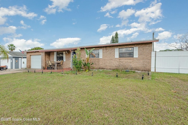 ranch-style home with a garage, brick siding, a front yard, and fence