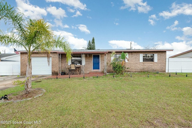 ranch-style home with fence, a front lawn, concrete driveway, and brick siding