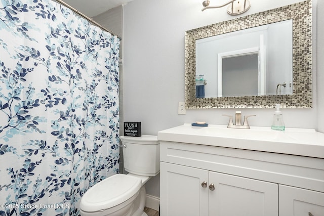 bathroom with toilet, a shower with shower curtain, and vanity