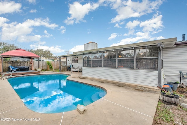 view of swimming pool featuring a gazebo, a fenced backyard, a fenced in pool, and a patio