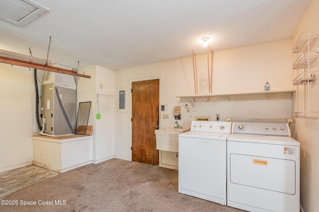 laundry area featuring a textured ceiling, laundry area, a sink, washer and dryer, and heating unit