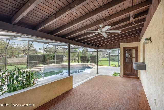 unfurnished sunroom with lofted ceiling with beams, ceiling fan, and wood ceiling