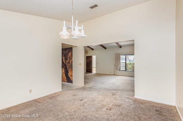 unfurnished room featuring baseboards, visible vents, an inviting chandelier, a textured ceiling, and carpet floors