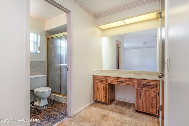 bathroom with vanity, a shower stall, and toilet