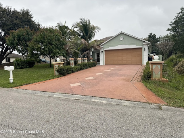 view of front of house featuring a garage, a front lawn, and concrete driveway