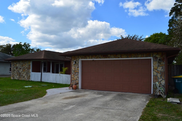 view of front of house with an attached garage, stone siding, and concrete driveway