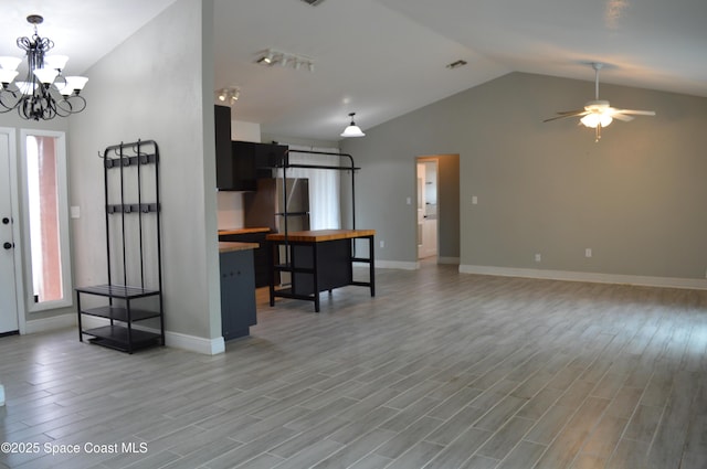 6110 Grissom Pkwy, Cocoa, FL 32927 - unfurnished living room with high vaulted ceiling, ceiling fan with notable chandelier, baseboards, light wood-type flooring, and visible vents