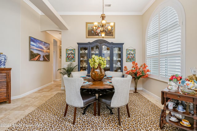 dining space featuring baseboards, visible vents, ornamental molding, and a chandelier