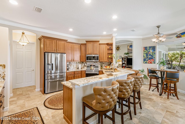 kitchen with arched walkways, stainless steel appliances, light stone counters, and open shelves