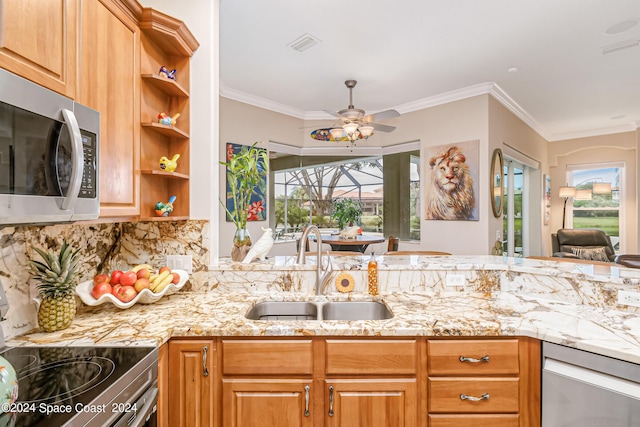 kitchen with stainless steel appliances, light stone counters, a sink, and a ceiling fan