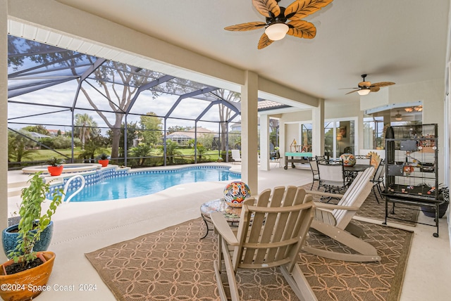 view of swimming pool with outdoor dining area, a pool with connected hot tub, glass enclosure, a patio area, and ceiling fan